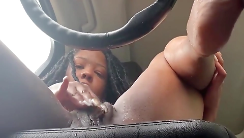 Busty ebony milf with a tattoo on her ass fucks her pussy