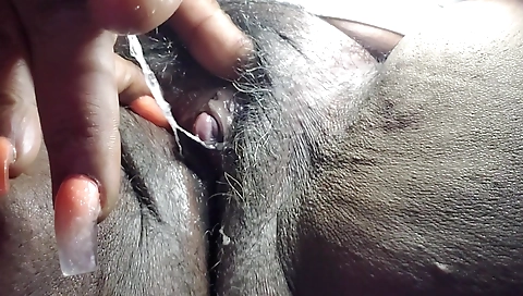 Mature ebony chick shows her shaved pussy on camera